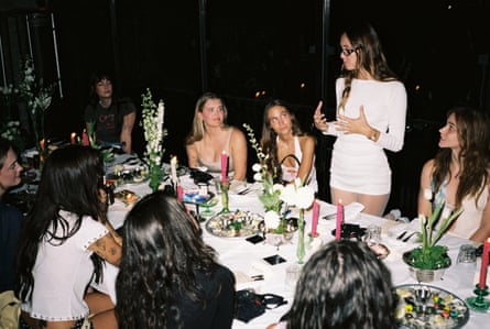 a woman speaking to a table of people