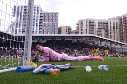 Manchester United’s goalkeeper Altay Bayindir lies on the pitch looking dejected after Mathias Jensen scores Brentford’s third.