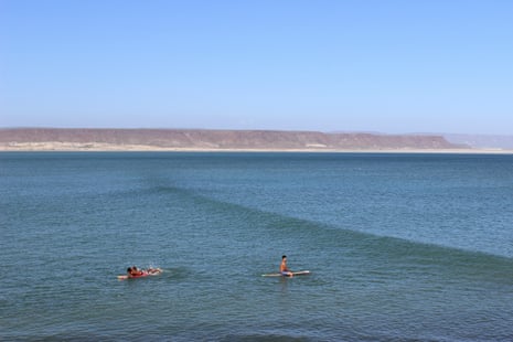 Surfers wait for the next wave in San Juanico, Las Barrancas in north-west Mexico