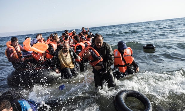 Syrian refugees arrive on the shores of Lesbos island in Greece in an inflatable boat from Turkey.