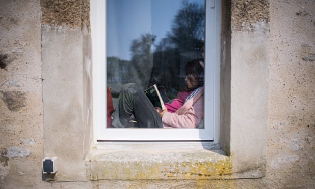 A girl reading in a window in France