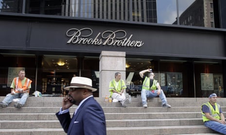 CORRECTS DATE OF PHOTO TO AUG. 4, 2011, INTEAD OF SEPT. 11, 2001 - FILE - In this Aug. 4, 2011, file photo, a man passes a Brooks Brothers store on Church Street in New York’s financial district. The 200-year-old fashion retailer that says it’s put 40 U.S. presidents in its suits, is filing for bankruptcy protection on Wednesday, July 8, 2020. (AP Photo/Mark Lennihan, File)