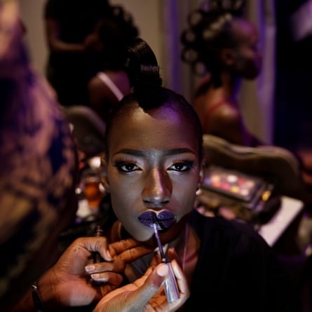 A models gets her makeup done backstage during Dakar fashion week, June 2017