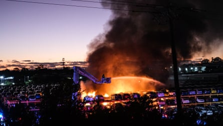 A firefighter battles the blaze at the Pickles car yard in Perth, Western Australia