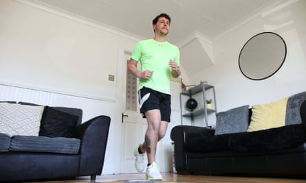 Col Bignell trains in preparation for his marathon in his front room.