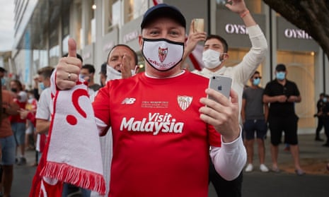 A Sevilla fan wearing a mask