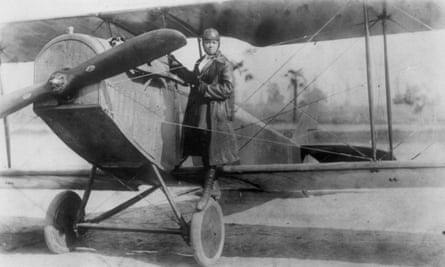 Photo of Bessie Coleman standing on the wing of her plane.