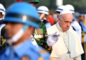 Pope Francis reviews a honour guard as he arrives at Dhaka International Airport in Bangladesh