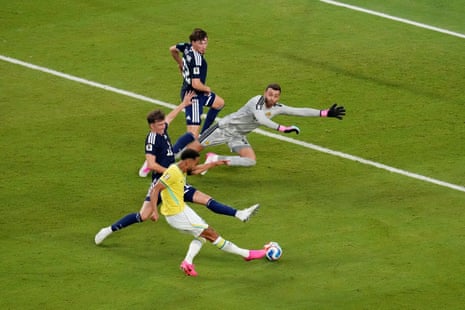 Matheus Cunha scores their third for Brazil past Angus Gunn.