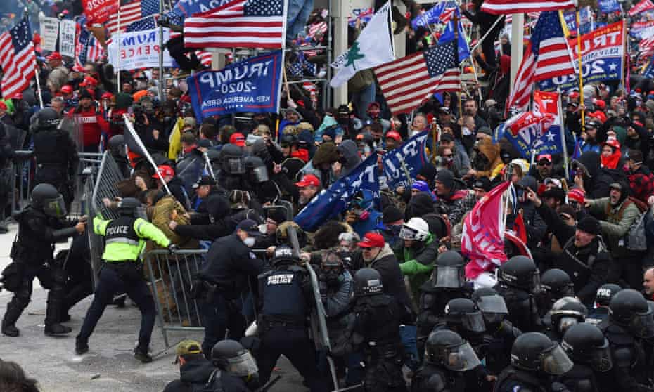 Trump supporters clash with police and security forces as they push barricades to storm the US Capitol in Washington DC on 6 January 2021.