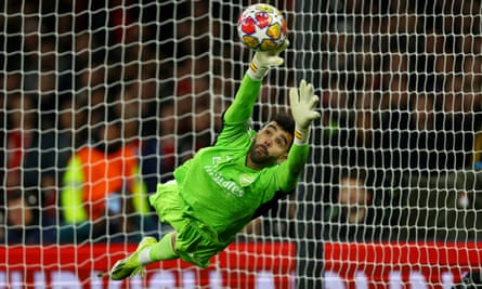 Arsenal's David Raya in action as FC Porto's Marko Grujic scores a penalty during the Champions League shootout