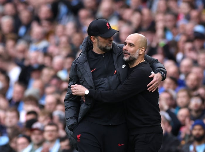 Liverpool manager Juergen Klopp and Manchester City manager Pep Guardiola embrace.