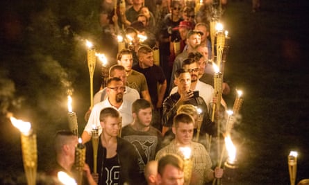 White nationalists and white supremacists carrying torches march through the University of Virginia campus last August.