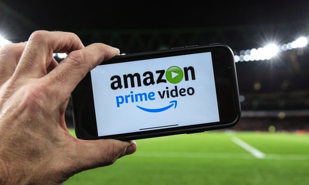 Amazon Prime image on mobile phone with football pitch in background