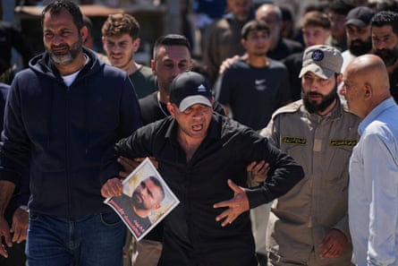 Mourners attend the funeral of four people killed in an Israeli strike, in Ansariyeh, Lebanon, on 8 May.