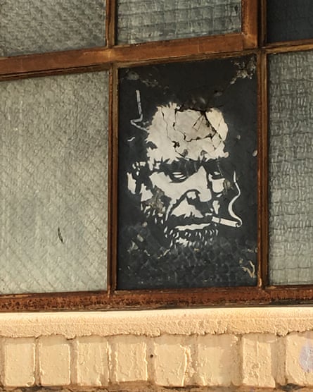 A stencil of poet Charles Bukowski, by Elvis Segarich, adorns a window in San Pedro.