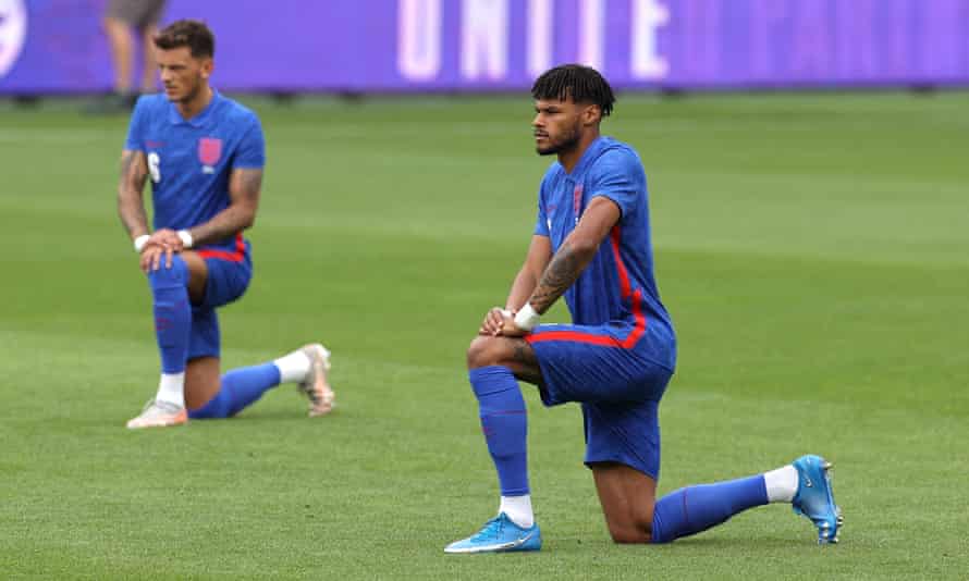 Tyrone Mings of England takes a knee.