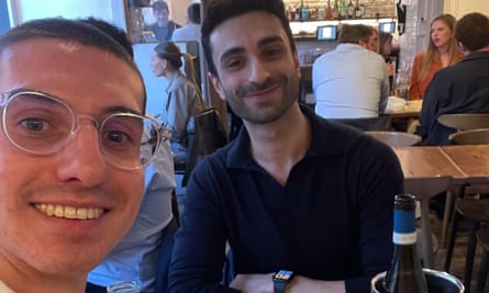 A smiling selfie of the couple in a restaurant