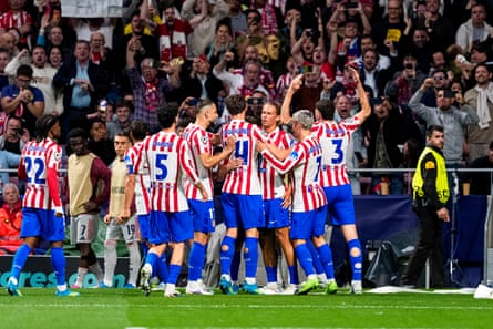 Atlético Madrid players celebrate in front of their fans after Julián Alvarez’s penalty equaliser.