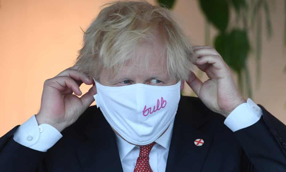 Boris Johnson puts on a Bulb-branded face mask