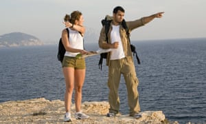 couple on holiday pointing in different directions