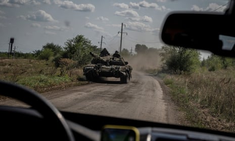 Ukrainian servicemen ride a tank near the village of Robotyne in the Zaporizhzhia region