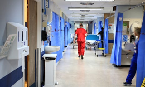 NHS staff member walking down a ward.