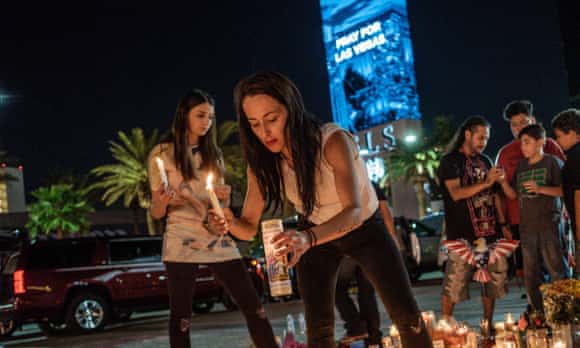 Dashenka Giraldo and her cousin Elisabeth Apcar light candles at a makeshift memorial on the North end of Las Vegas Boulevard just a few miles from where the Route 91 Harvest Music Festival was held