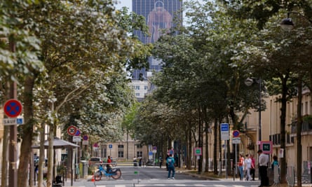 At the end of a blocked-off street near the Eiffel Tower, a huge image of French swimming hope Leon Marchand