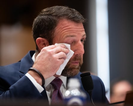Markwayne Mullin wipes tears from his look while relating a communicative during his Senate hearing.