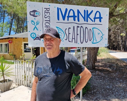 Man standing in front of sign reading ‘Ivanka Seafood’
