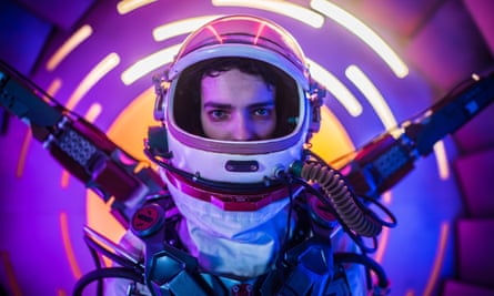 A man in a spacesuit inside a purple cylinder