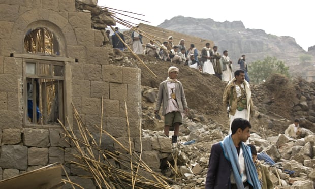 Yemenis stand amid the rubble of houses destroyed by Saudi-led air strikes in a village near Sana’a.