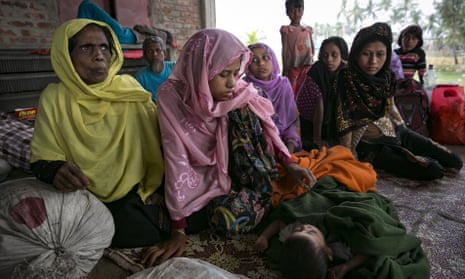 Rohingya women and children rest after crossing into Bangladesh at Cox’s Bazar on Friday, a day after the two governments signed a refugee repatriation deal.
