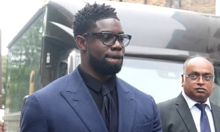 Micah Richards dressed in a suit leaving court in north London