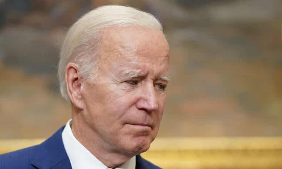 biden looks downward in close up photo