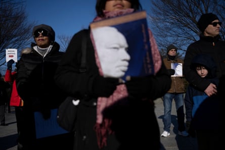 People listen to speakers at the Martin Luther King Jr Memorial on the National Mall in Washington, on Monday.