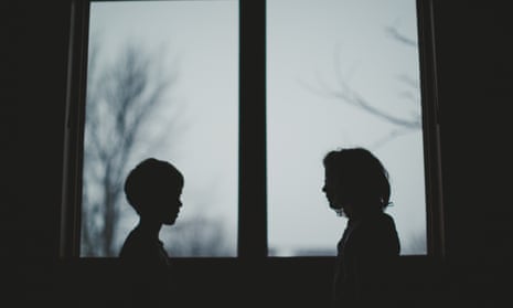 Boy and girl in silhouette by window