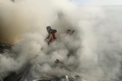 Palestinian firefighters work to extinguish a fire caused by an Israeli airstrike in Khan Younis refugee camp.