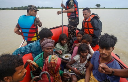 Flood victims are taken to safety by Nepalese soldiers from their flood-hit village of Kulari, Saptari.