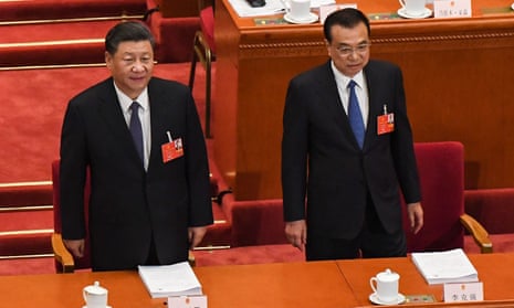 Chinese President Xi Jinping (L) and Premier Li Keqiang (R) arrive for the opening session of the National People’s Congress in Beijing.
