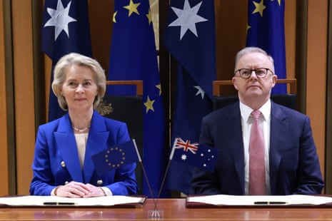 European Commission president Ursula von der Leyen (L) and Australian prime minister Anthony Albanese (R) prepare to sign agreement documents during a signing ceremony in Canberra.