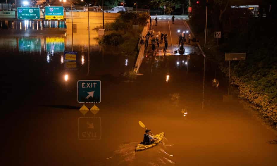 A kayaker paddles down a portion of Interstate 676 in Philadelphia. The massive storm system roared across the US and dumped record-breaking rain.