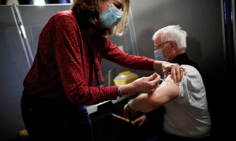 A man receives the Pfizer-BioNTech vaccine at a centre in Paris.