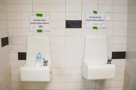signs posted above water fountains read 'do not drink until further notice'
