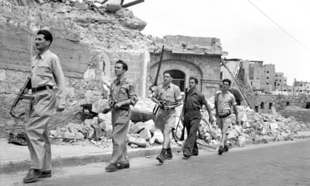 Members of the Haganah patrol the ruins of Haifa in May 1948