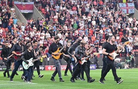 Performers on the pitch before kick-off.