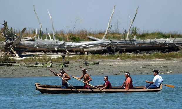 Members of the Wiyot Tribe paddle a dugout redwood canoe across Humboldt Bay in Eureka, California.