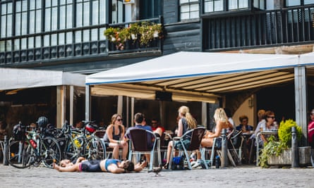 A well-earned rest at a cafe, several cyclists sitting outside at tables
