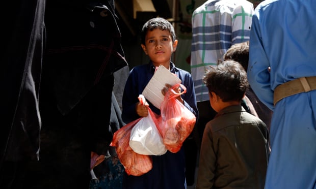 A Yemeni child receives a meal from a charitable centre in Sana’a
